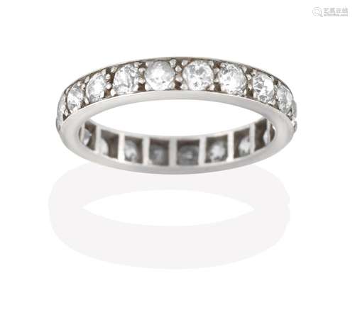 A Diamond Eternity Ring, the twenty old cut diamonds in white claw and channel settings, total