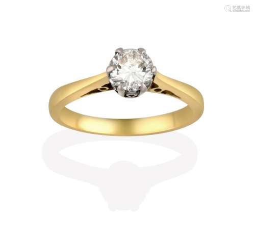 A Diamond Solitaire Ring, the round brilliant cut diamond in a white claw setting, to a tapered