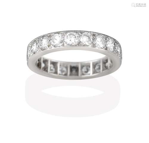 A Diamond Eternity Ring, the twenty round brilliant cut diamonds in white claw and channel settings,