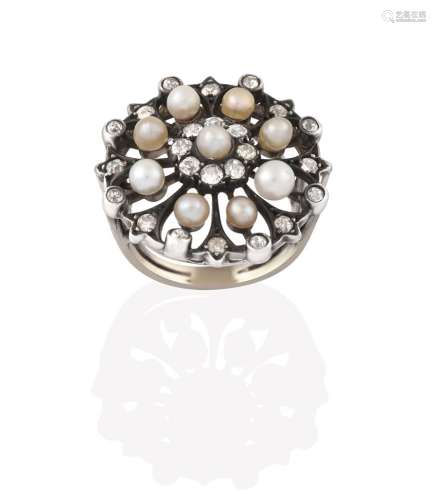 A Diamond and Seed Pearl Cluster Ring, the circular openwork plaque with a seed pearl centrally