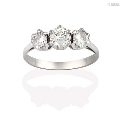 A Diamond Three Stone Ring, the round brilliant cut diamonds in white claw settings, to a tapered