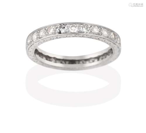 A Diamond Eternity Ring, the twenty-six round brilliant cut diamonds in white claw and channel
