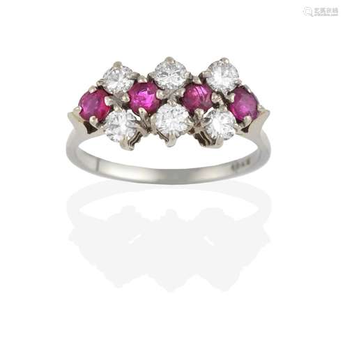 A Ruby and Diamond Cluster Ring, four round cut rubies spaced by three pairs of round brilliant