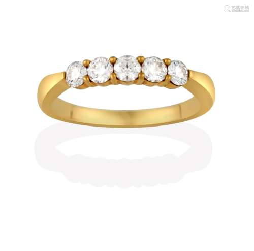 A Diamond Five Stone Ring, the round brilliant cut diamonds in yellow claw settings, to a plain