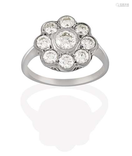 A Diamond Cluster Ring, the round brilliant cut diamond within a border of smaller round brilliant