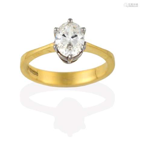 A Diamond Solitaire Ring, the oval cut diamond in a white claw setting, to a yellow tapered shoulder