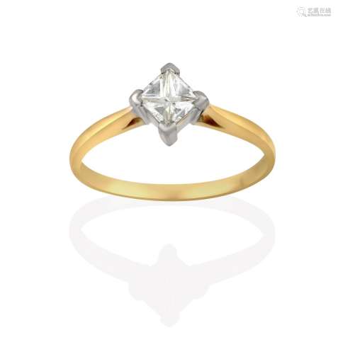 A Diamond Solitaire Ring, the princess cut diamond in a white four claw setting, to a yellow tapered