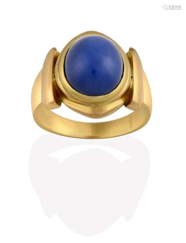 A Synthetic Star Sapphire Ring, the oval cabochon synthetic star sapphire in a yellow rubbed over