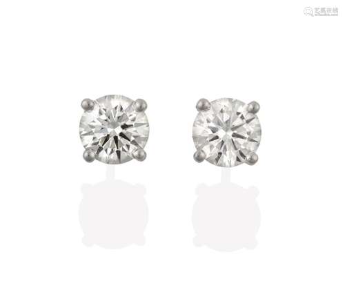 A Pair of 18 Carat White Gold Diamond Solitaire Earrings, the round brilliant cut diamonds in four