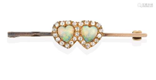 An Edwardian Opal and Diamond Brooch, two heart shaped cabochon opals within a border of old cut