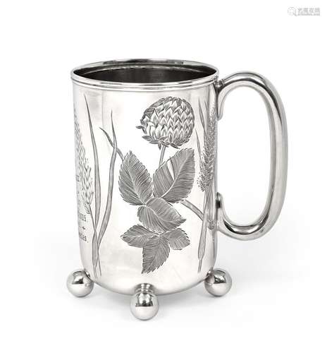 A Victorian Silver Mug, by Barker Brothers, Birmingham, 1895, cylindrical and on four ball feet, the