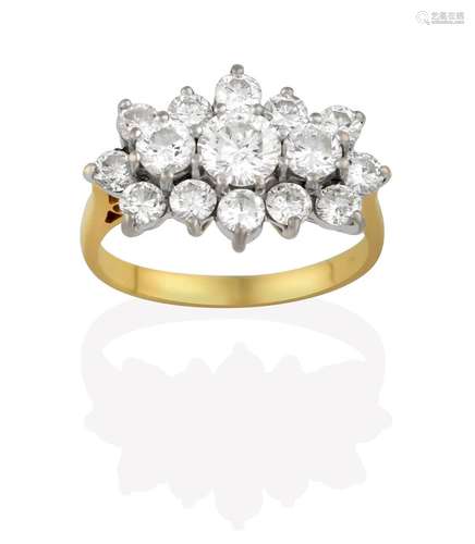 A Diamond Cluster Ring, three graduated round brilliant cut diamonds within an undulating border