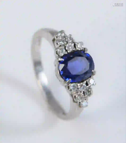 Platinum Ring set with center oval blue stone, flanked