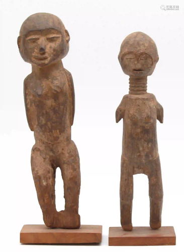 2 female figures. One with a long neck and ribbons.