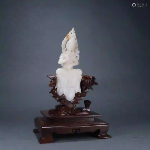 A WHITE JADE CARVING OF GUANYIN FIGURE ON STAND