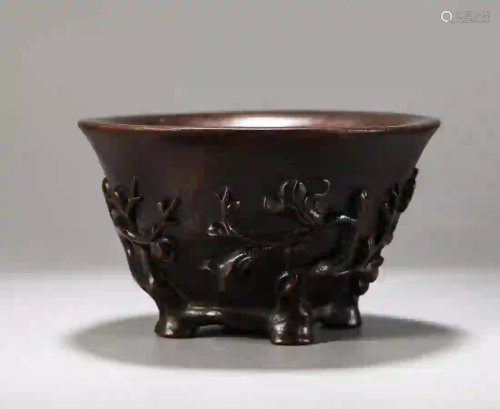 A CARVED BAMBOO CUP WITH PLUM MOTIF
