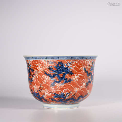 Ming A small red cup in blue and white glaze