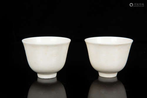 PAIR OF WHITE GLAZED IMPRESSED 'DRAGON' CUPS