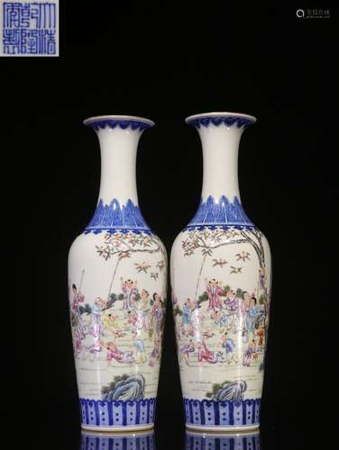 PAIR OF BLUE AND WHITE FAMILLE ROSE 'CHILDREN' VASES