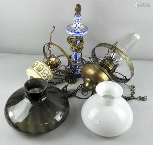 Two hanging oil lamps along with a cermic table lamp