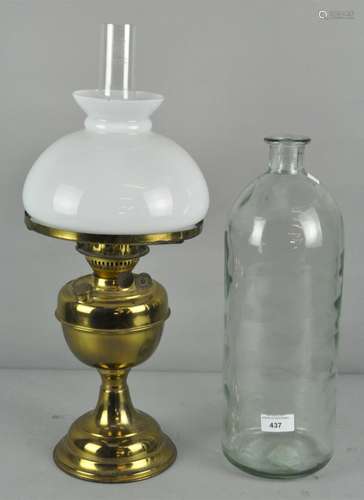 A 20th century brass oil lamp with opaque glass shade and clear funnel,