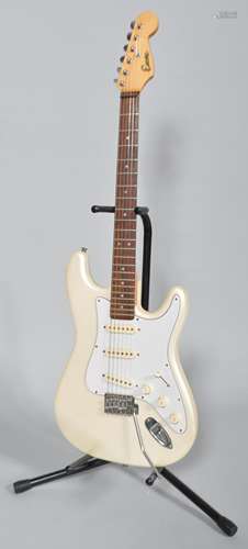 An Encore electric guitar, ivory coloured with soft travelling case,