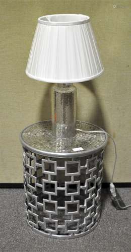 A contemporary round side table and matching lamp.