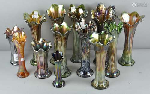 A collection of assorted green carnival glass fluted vases. Tallest; 32cm.