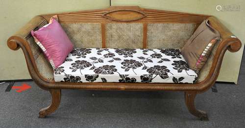 A Biedermeier hardwood bergere sofa with raised back, in ribbed decoration,