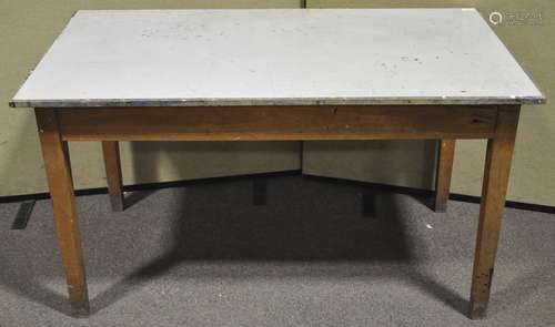 A 20th century beech wood school table raised on square tapering legs. Measures; 76cm x 137cm.