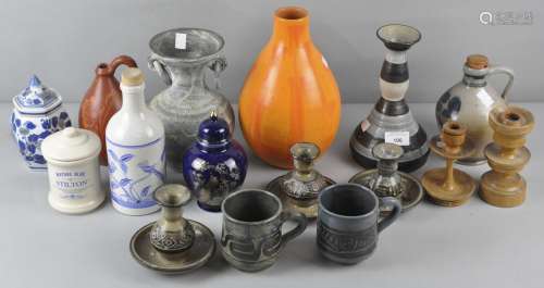 A collection of pottery vases and candlesticks of varying shapes and designs,