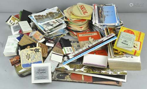 A collection of assorted beer mats, postcards,