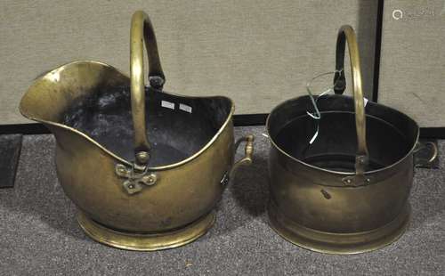 Two late 19th Century brass coal buckets with swing handles atop. Largest; 43cm high.