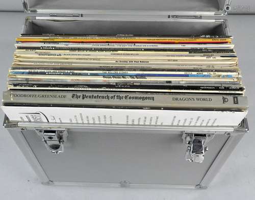 A metal case containing a collection of Vinyl LP's, including The Beatles please,