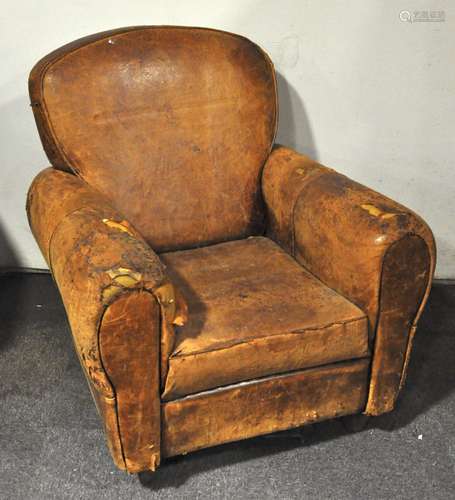 A vintage well worn leather club style armchair,