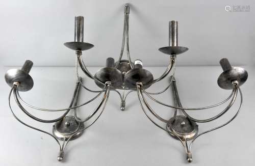 A group of three blackened/finished steel wall sconces, each with two bowls to fancy arms,