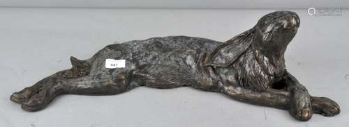 A large modernist stylized bronzed resin figure of a recumbent hare,