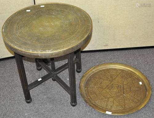 An Islamic Brass topped tray top table, raised upon a folding Oak base, 60cm high x 59cm,