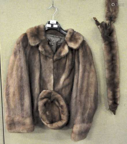 A mink coat and a hat and two pelts