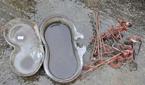 Two cattle water drinking bowls and some branding irons