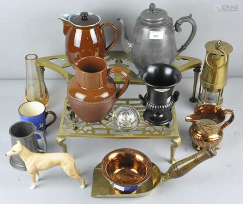 A collection of assorted items including rectangular brass trivet, a curved brass trivet,