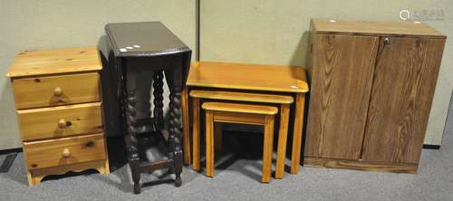 A nest of three tables, 65cm wide; a twin door cupboard,