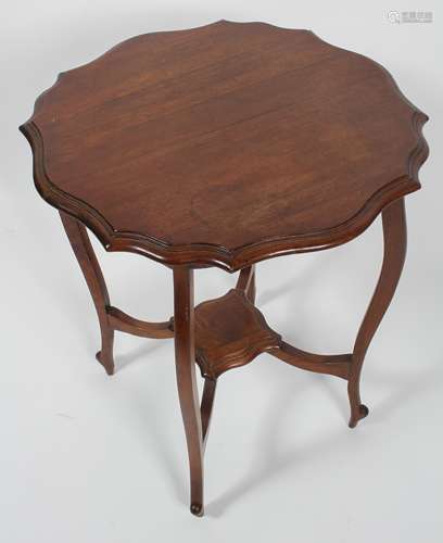 An Edwardian shaped mahogany occasional table with four cabriole legs stretchered to a centre shelf