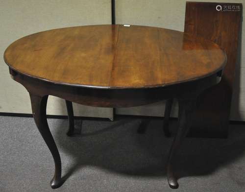 A late 19th/early 20th century mahogany extending oval tea table with one leaf,