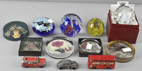 A collection of assorted glass paperweights to include some pictorial examples,