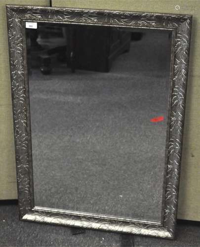 A contemporary rectangular Mirror with silvered floral frame,