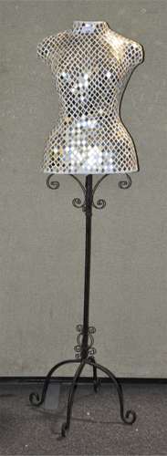 A mirror inlaid decorative mannequin on a wrought iron stand,