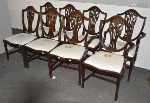 A group of eight stained oak shield back style dining chairs with pierced vase splats