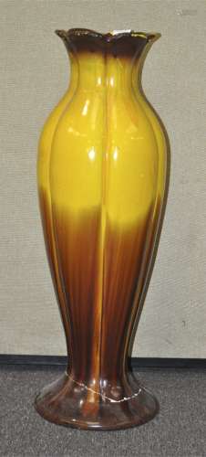 A large pottery floor vase, glazed in graduated yellow and brown, 82 cm high, a/f foot damaged.