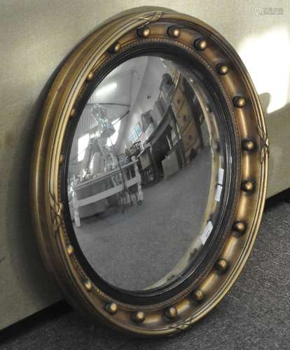 An antique style convex round mirror with gilt frame,